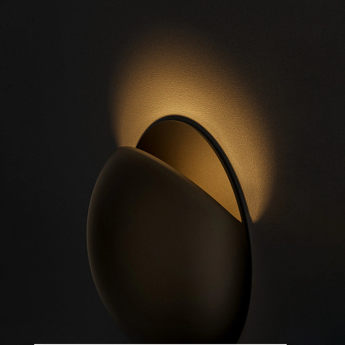 Pearl black wall lamp lighting a stairway