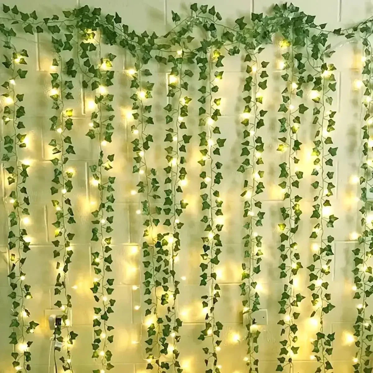 Leaf curtain lights hanging on a bedroom wall with warm white LEDs