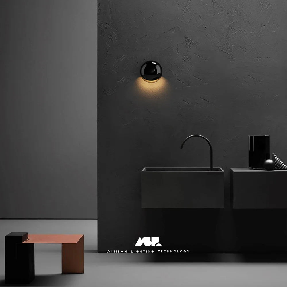 Wall light mounted indoors beside a bed