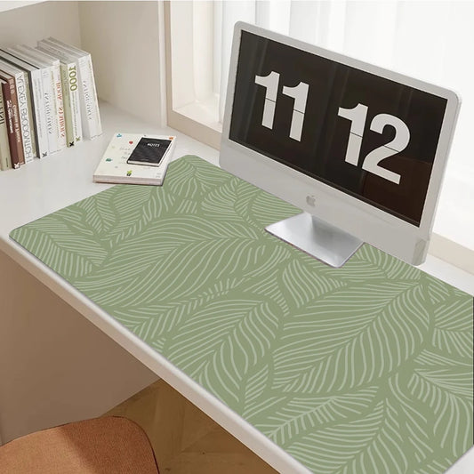 Sage green desk mat with a leaf print