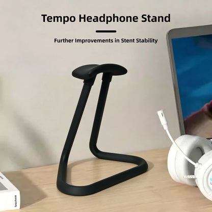 Headphone stand empty on a desk next to a keyboard