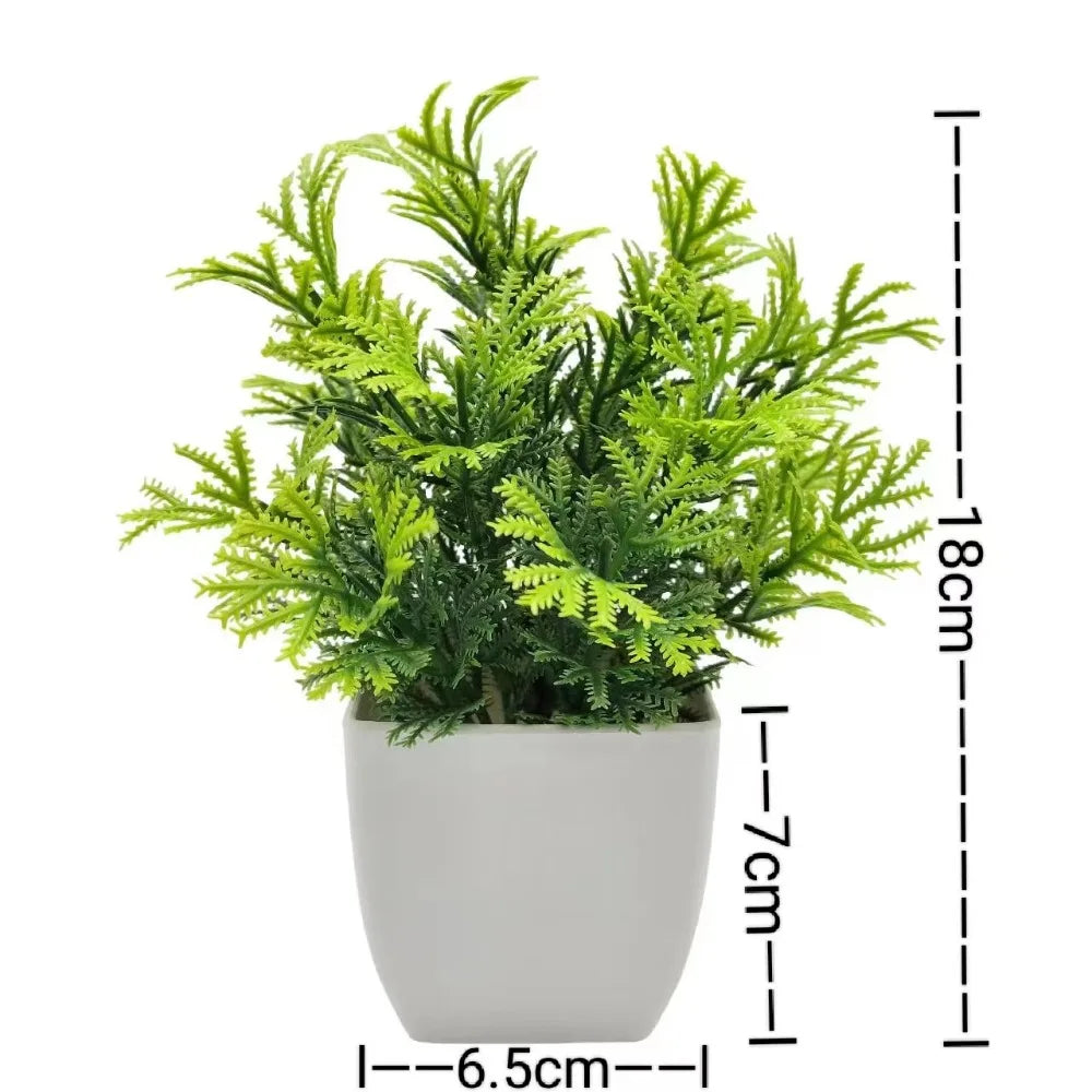 Small artificial potted plant with green foliage in a white pot, view 7