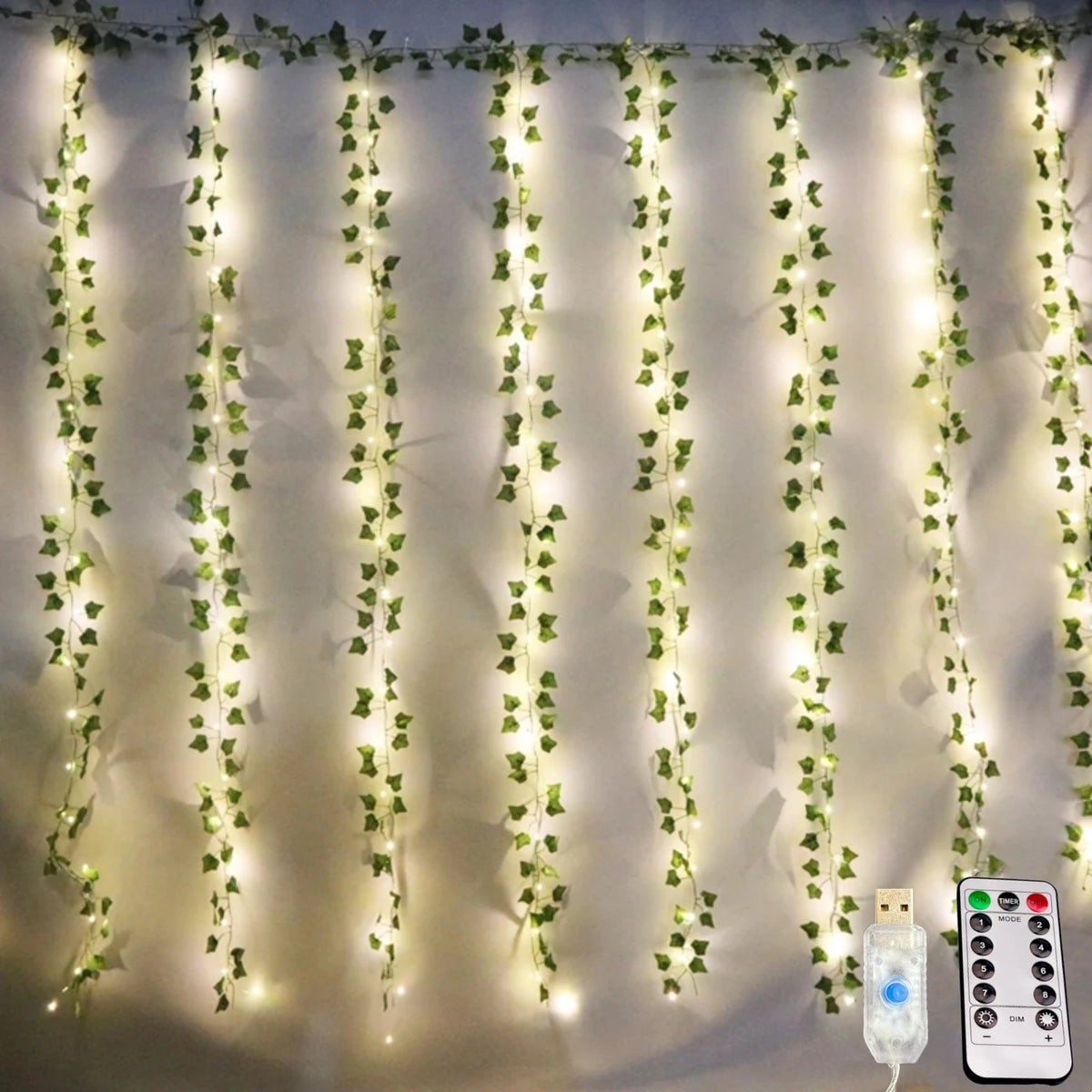 Artificial ivy garland string lights lit behind a bed