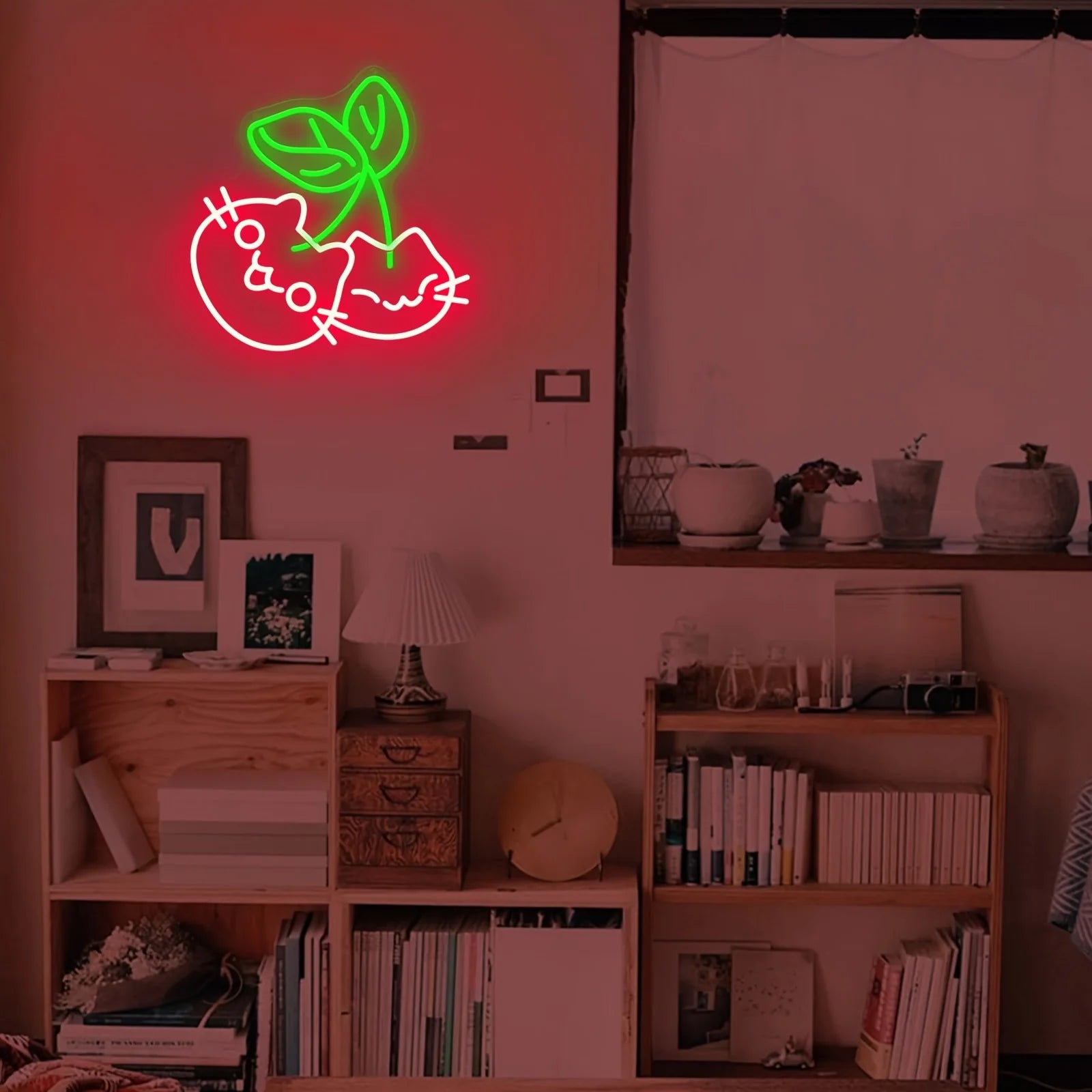 Neon sign of a cat with a green leaf above a shelf with books and decor