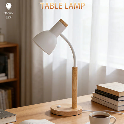 E27 desk lamp with wooden base lit on a study desk