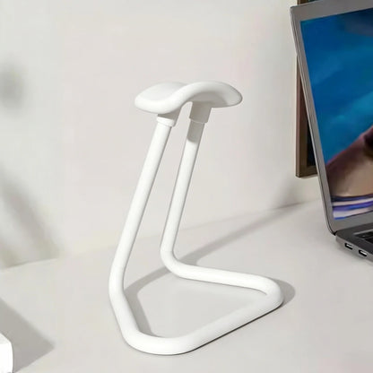 Headphone stand holding gaming headphones at a desk
