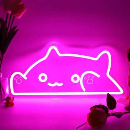 Neon sign of a cat face on a pink background with flowers.