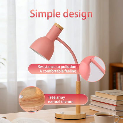 Pink desk lamp on a wooden base beside books