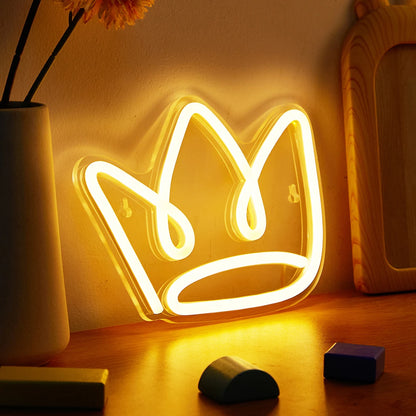 Neon crown light on a wooden surface with a soft focus background