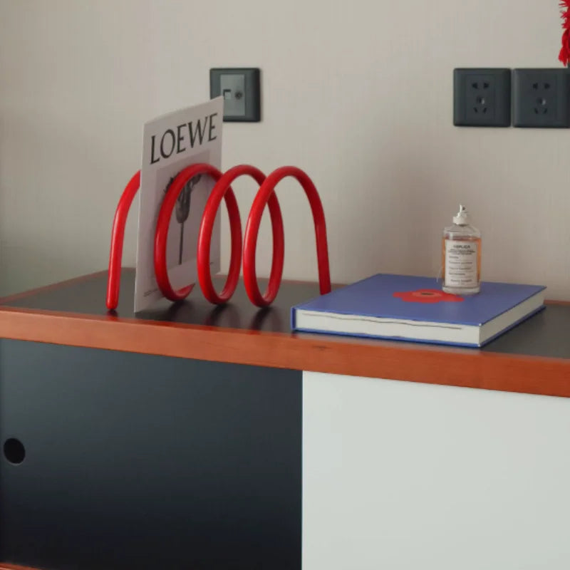 Red tabletop book rack on a study desk
