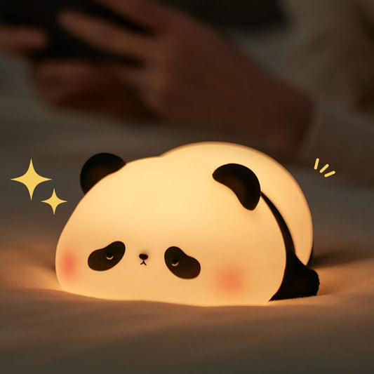 Cute panda-shaped night light on a soft surface with a blurred background