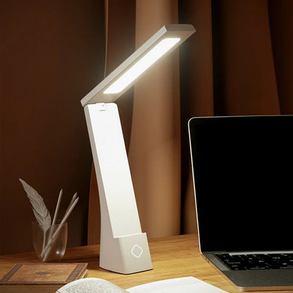 Foldable desk lamp shown in three body colours