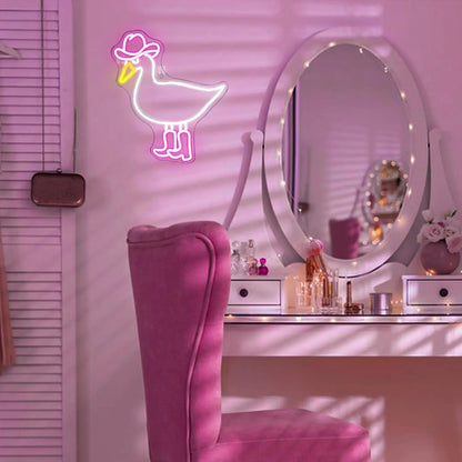 Neon duck sign above a vanity with mirror and makeup.