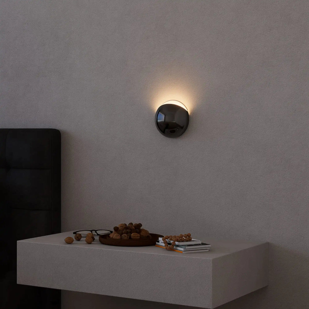 Mirror chrome outdoor wall light on a garden wall