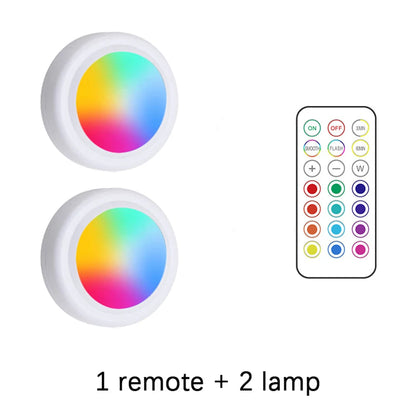 Two RGB light bulbs with a remote control on a white background