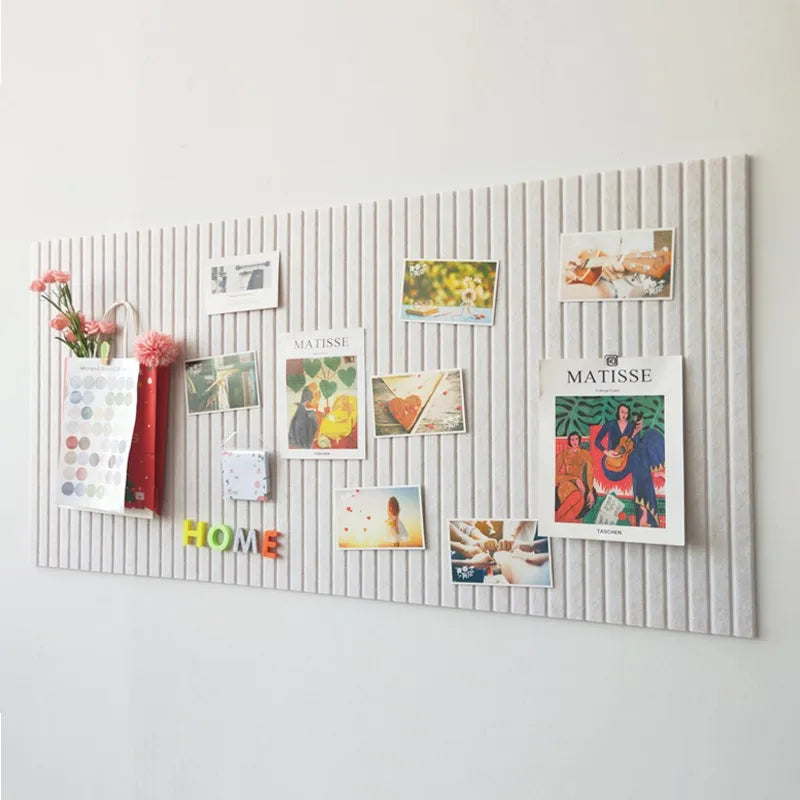 Felt pin board mounted on a wall with photos and notes pinned to it