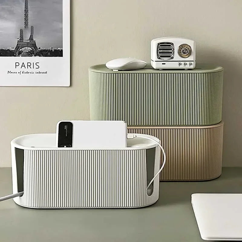 White cable tidy box with a phone charging on the lid