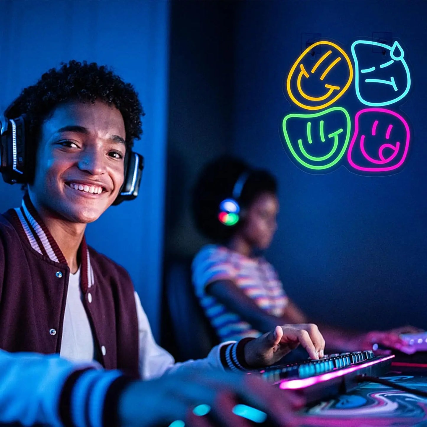 Person wearing headphones and interacting with a gaming console in a dark room with colorful smiley face symbols.
