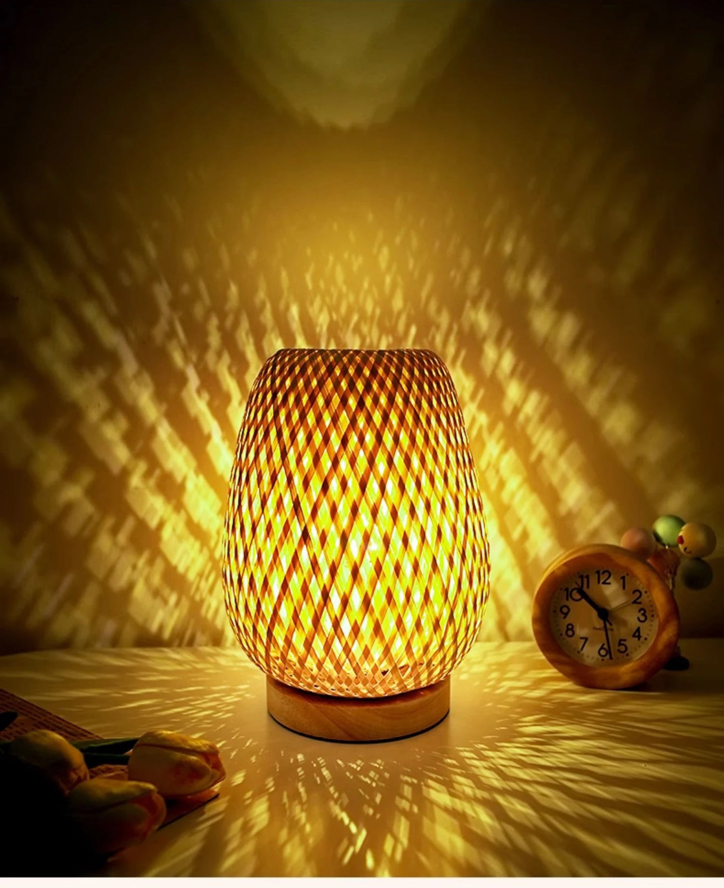Bamboo bedside lamp on a nightstand next to a bed