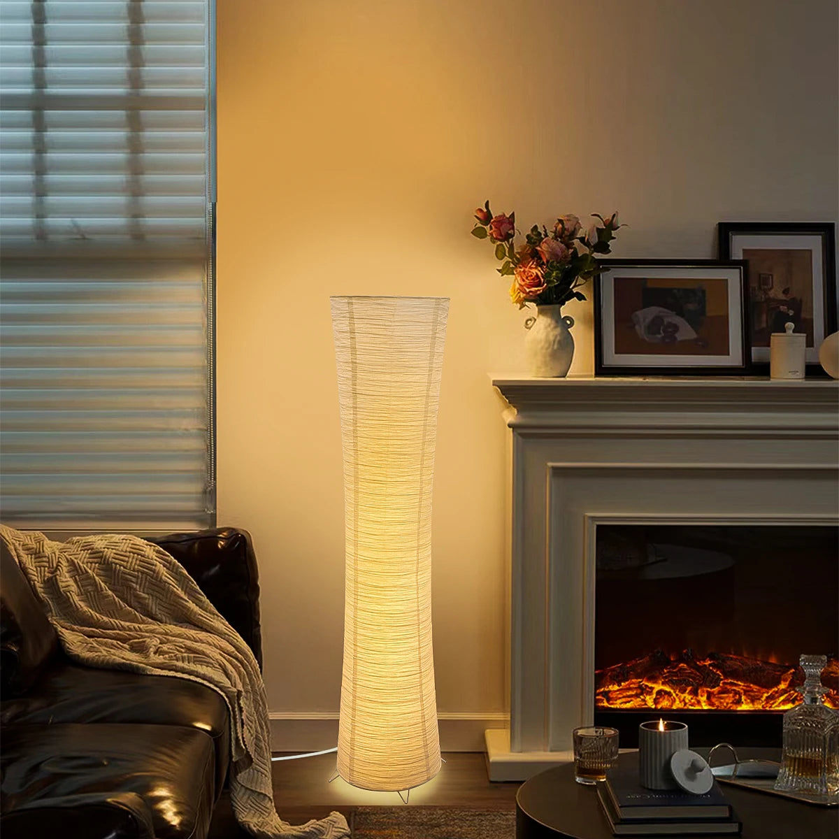 Living room with a fireplace, floor lamp, and decorative items.