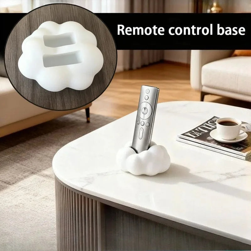 White cloud holder with TV remotes on table