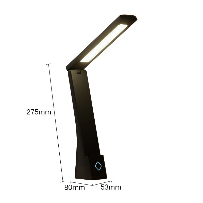 Compact folding lamp on a study desk beside books