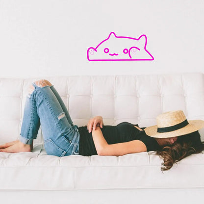 Person lying on a white couch wearing a black top, blue jeans, and a straw hat with a pink cat icon above them.