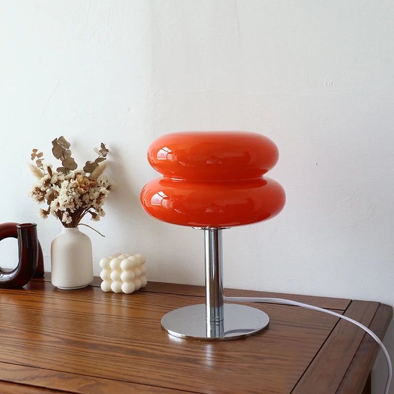 Pastel glass lamp glowing on bedside table