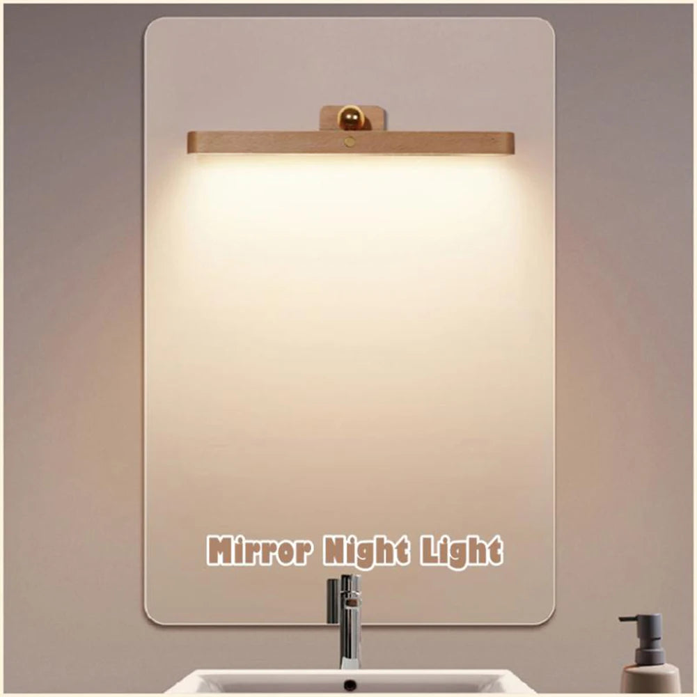 Close-up of wooden cordless mirror light showing LED detail and adjustable positioning mechanism