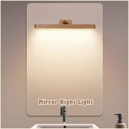 Close-up of wooden cordless mirror light showing LED detail and adjustable positioning mechanism