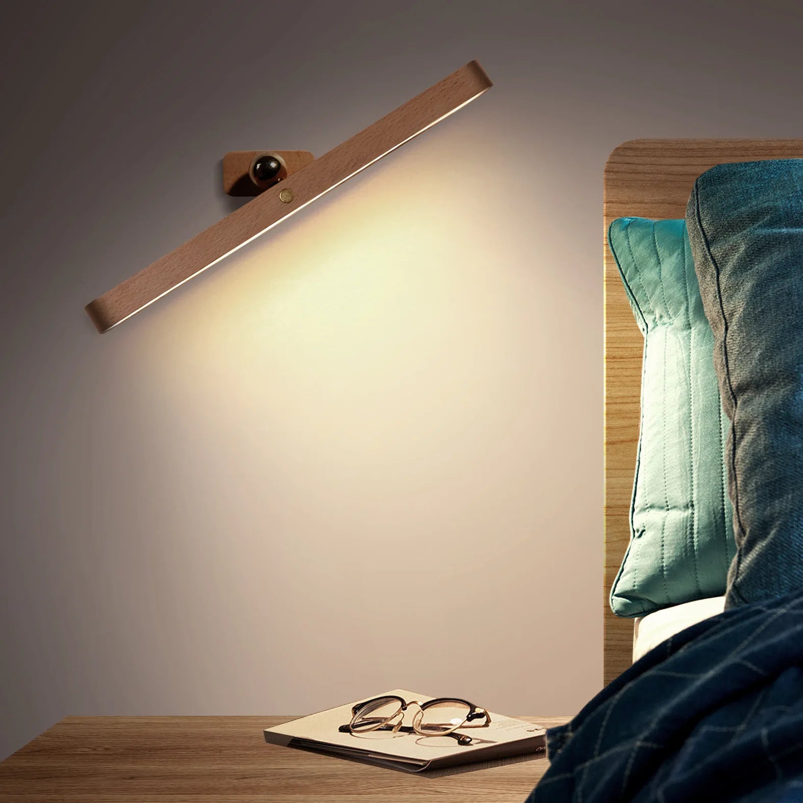 Wooden cordless mirror light positioned on bedside table, glowing as night light and reading lamp