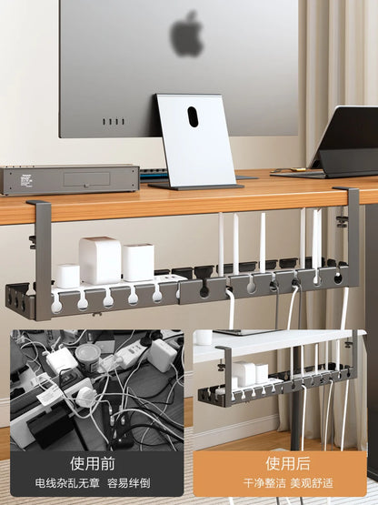 Black steel cable tidy mounted beneath a desktop