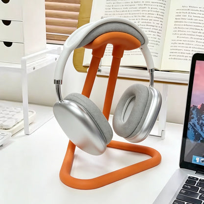 Universal headphone stand holding a headset on a desk
