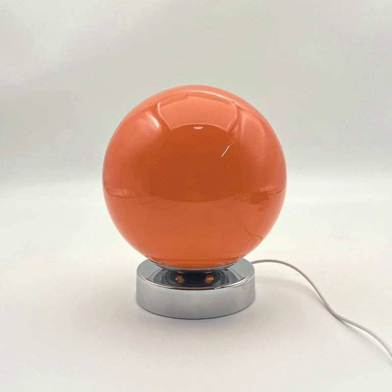 Vintage glass bedside lamp in a simple bedroom setting