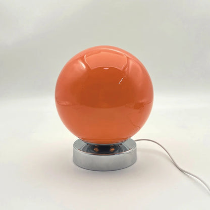 Vintage glass bedside lamp in a simple bedroom setting