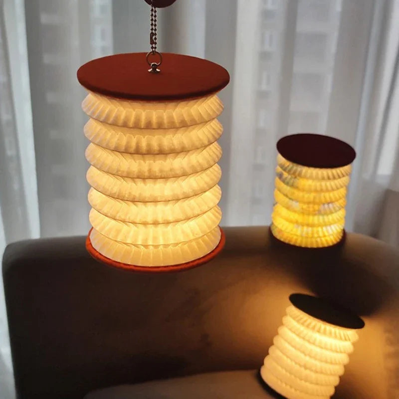 Rechargeable night light glowing beside a bed