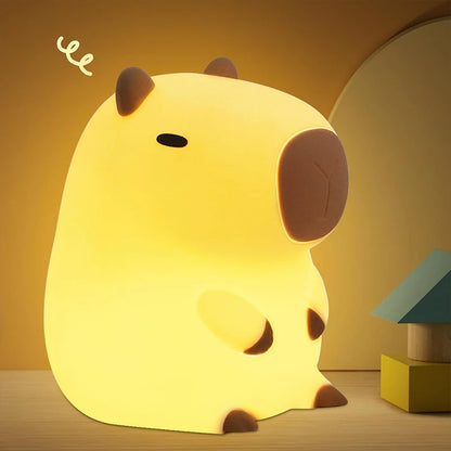 Cute animal-shaped night light on a wooden surface with a warm yellow background