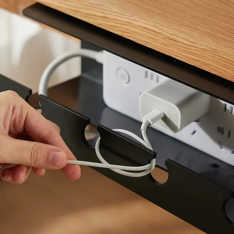 Black under desk cord holder with cables inside