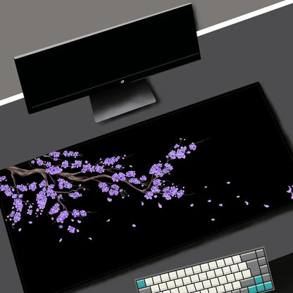 Black desk mat with a purple cherry blossom design