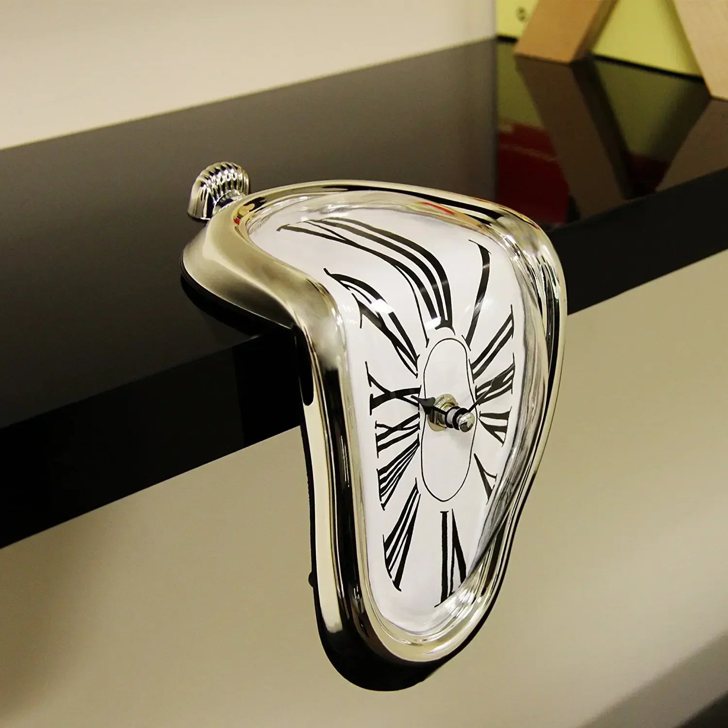 Gold Dali style melted clock hanging over a mantelpiece