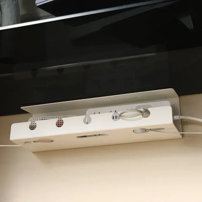 Clamp on cable tray fitted under a desk holding a plug strip