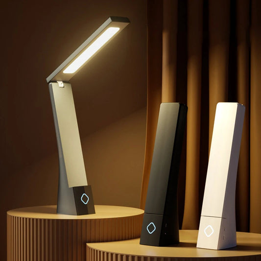 Foldable desk lamp standing open on a bedside table
