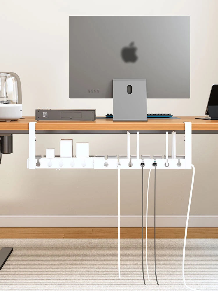 White under desk cord organiser filled with adapters