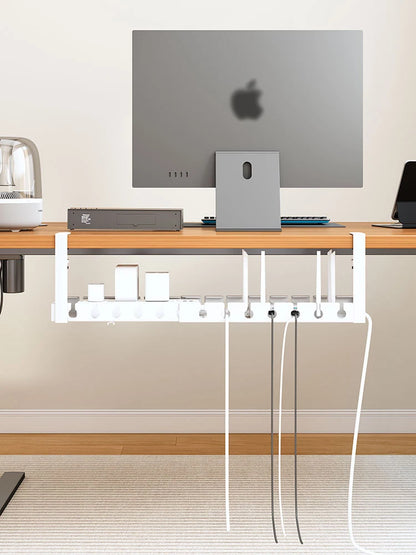 White under desk cord organiser filled with adapters