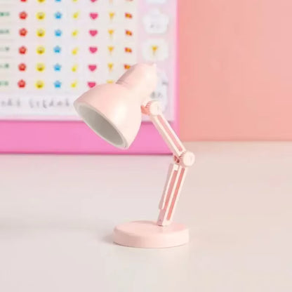 Magnetic base clip light on laptop desk